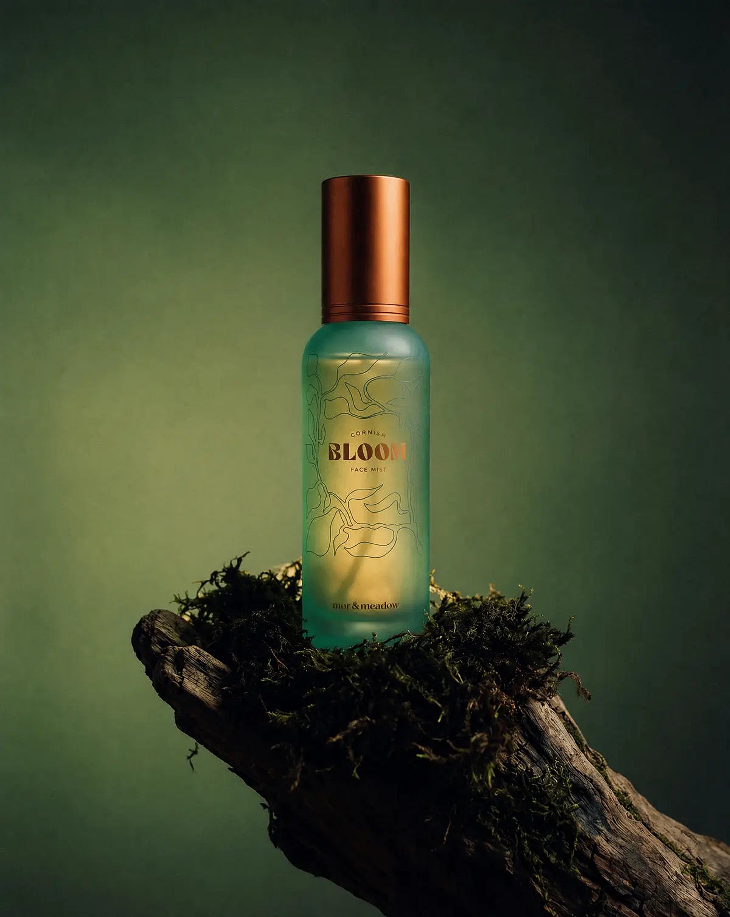 Cornish Bloom bottle resting on moss and driftwood